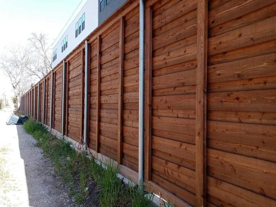 Long finished horizontal wood fence